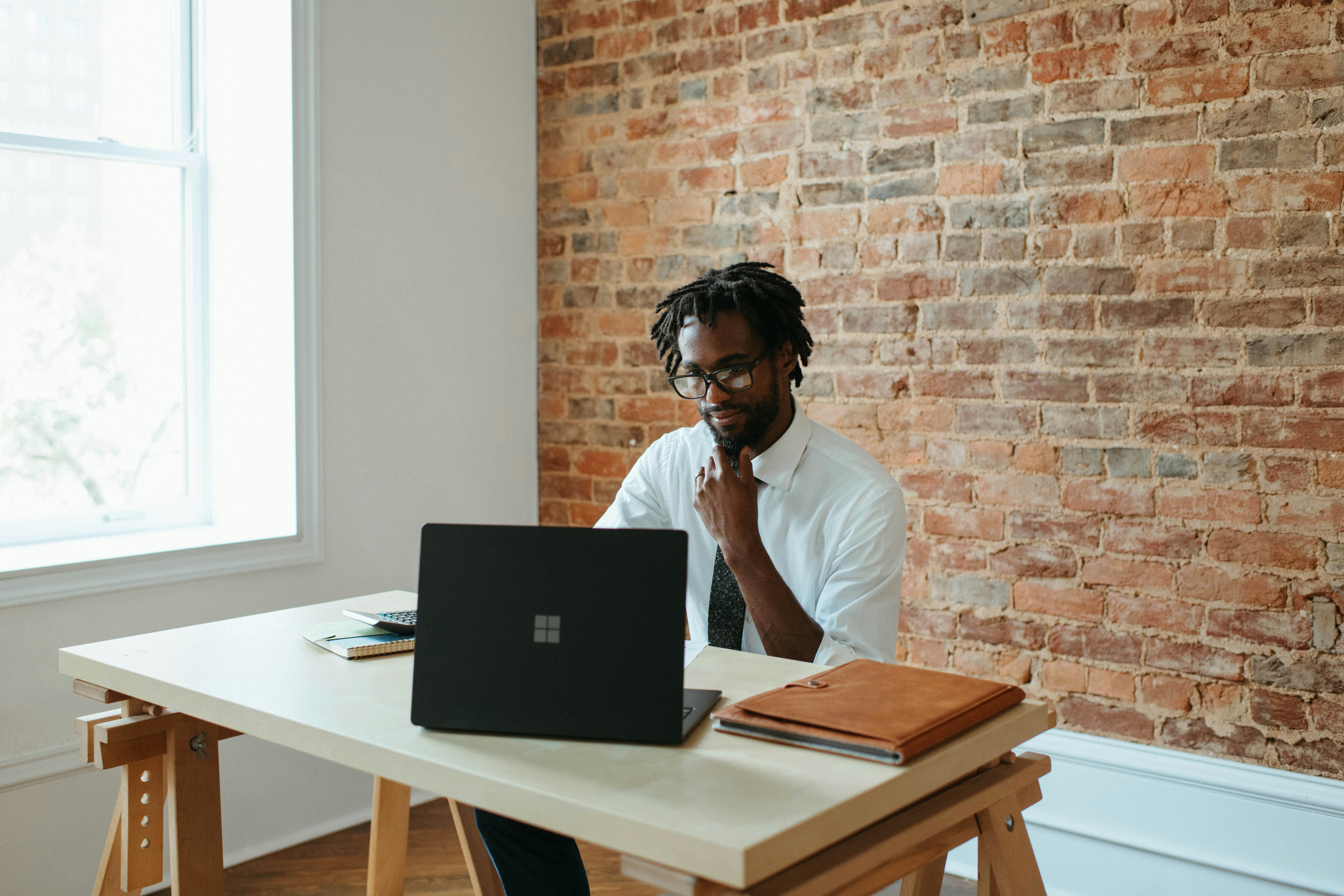 man sitting at desk with laptop
